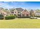 Inviting front yard with lush landscaping and a charming two-story home, blending elegance with curb appeal at 500 Poplar Creek Xing, Canton, GA 30114