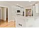Bright kitchen boasts white cabinetry, marble countertops, and stainless steel appliances at 500 Poplar Creek Xing, Canton, GA 30114