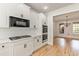 Bright kitchen boasts white cabinets and countertops and stainless steel appliances at 500 Poplar Creek Xing, Canton, GA 30114
