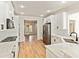 Spacious kitchen features white cabinets, stainless steel appliances, and hardwood floors at 500 Poplar Creek Xing, Canton, GA 30114