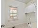 Clean and functional laundry room with sink, storage cabinets, and window view at 500 Poplar Creek Xing, Canton, GA 30114
