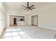 Open-concept space with hardwood floors transitioning to a cozy carpeted living area at 500 Poplar Creek Xing, Canton, GA 30114
