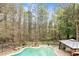 Enjoy the view from above of this lovely backyard pool and wooded property at 500 Poplar Creek Xing, Canton, GA 30114
