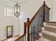 View of front door and staircase with wood railing and carpet stairs at 500 Poplar Creek Xing, Canton, GA 30114