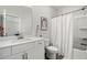 Well-lit bathroom featuring a single vanity with a tub and shower combination and white curtain at 234 Retreat Ln, Canton, GA 30114