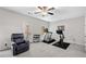 Bright bonus room featuring a ceiling fan, comfortable chair, and modern fitness equipment at 234 Retreat Ln, Canton, GA 30114