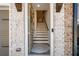 Inviting entryway features a staircase, brick accents, a decorative wreath, and a glimpse of the upper level at 234 Retreat Ln, Canton, GA 30114
