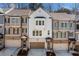 Charming townhome exterior features brick accents, a garage, and a welcoming front entrance with a wreath at 234 Retreat Ln, Canton, GA 30114