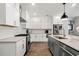 Modern kitchen with white cabinets, granite countertops, stainless steel appliances, and a functional center island at 234 Retreat Ln, Canton, GA 30114