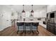 Bright kitchen features white cabinets, stainless steel appliances and oversized island with bar seating at 234 Retreat Ln, Canton, GA 30114
