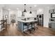 Stylish kitchen featuring an island with seating, stainless steel appliances, and a view of the adjacent living space at 234 Retreat Ln, Canton, GA 30114