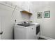 A clean laundry room featuring a front-load washer and dryer with overhead storage at 234 Retreat Ln, Canton, GA 30114