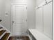 This is a great mudroom featuring a door to a closet and bench with coat hooks to hang your things at 234 Retreat Ln, Canton, GA 30114