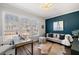 Well-lit home office with desk, sofa and large window overlooking the neighborhood at 234 Retreat Ln, Canton, GA 30114