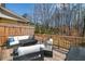 Relax outdoors on the deck with comfortable seating in this fenced in yard with mature trees at 234 Retreat Ln, Canton, GA 30114