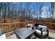 Relax outdoors on the deck with comfortable seating in this fenced in yard with mature trees at 234 Retreat Ln, Canton, GA 30114
