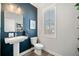 Modern powder room with pedestal sink, stylish mirror, and contemporary fixtures at 234 Retreat Ln, Canton, GA 30114