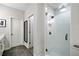 Bright white bathroom with a frameless glass shower enclosure and contrasting black hardware at 234 Retreat Ln, Canton, GA 30114