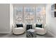 Bright sitting area with two chairs, an accent table and floor lamp set against three windows at 234 Retreat Ln, Canton, GA 30114