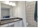 Bright bathroom featuring granite countertop and shower with white tile at 241 Quail Run, Roswell, GA 30076