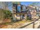 Charming two-story home featuring dormer windows, a front lawn, and a welcoming entrance at 241 Quail Run, Roswell, GA 30076