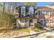 Charming two-story home featuring dormer windows, a front lawn, and a welcoming entrance at 241 Quail Run, Roswell, GA 30076