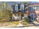 Charming townhome featuring a well-maintained lawn and inviting rocking chairs on the front porch at 241 Quail Run, Roswell, GA 30076