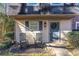 Inviting front porch featuring rocking chairs, a wreath, and a meticulously kept lawn and garden at 241 Quail Run, Roswell, GA 30076