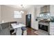 Eat-in kitchen includes stainless appliances, a black refrigerator, and booth seating at 241 Quail Run, Roswell, GA 30076