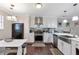 Modern kitchen with white cabinets, stainless steel appliances, and a stylish backsplash at 241 Quail Run, Roswell, GA 30076