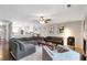 Open concept living room boasts a fireplace, hardwood floors, and an open view to the updated kitchen at 241 Quail Run, Roswell, GA 30076