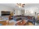 Spacious living room with a large sectional couch and a ceiling fan at 241 Quail Run, Roswell, GA 30076