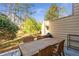 Enjoy outdoor living on this patio with wooded views, seating for four, and a grill at 241 Quail Run, Roswell, GA 30076