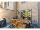 This patio features a wooden table, seating for four, and outdoor lighting for evening enjoyment at 241 Quail Run, Roswell, GA 30076
