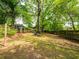 Large backyard with mature trees and a fire pit area at 646 Catherine Sw St, Atlanta, GA 30310