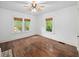 Bright bedroom with hardwood floors, ceiling fan and two large windows at 646 Catherine Sw St, Atlanta, GA 30310