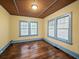 Bedroom featuring blue trim, two windows and hardwood floors at 646 Catherine Sw St, Atlanta, GA 30310