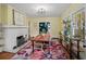 Bright dining room with brick fireplace, hardwood floors, and a stylish rug at 646 Catherine Sw St, Atlanta, GA 30310