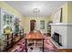 Sunlit dining room featuring a brick fireplace, hardwood floors, and modern decor at 646 Catherine Sw St, Atlanta, GA 30310