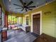 Comfortable screened front porch with ceiling fan, seating, and charming details at 646 Catherine Sw St, Atlanta, GA 30310