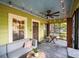 Inviting screened porch with seating, ceiling fan, and wood table for relaxing at 646 Catherine Sw St, Atlanta, GA 30310