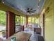 Spacious screened front porch with ceiling fan, outdoor seating, and string lights at 646 Catherine Sw St, Atlanta, GA 30310