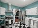 Kitchen boasts stainless steel appliances, checkered floor, and an open design at 646 Catherine Sw St, Atlanta, GA 30310
