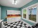 Charming kitchen with black and white checkered floors and bright natural light at 646 Catherine Sw St, Atlanta, GA 30310