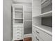 Organized walk-in closet with shelving and drawer units for optimal storage at 646 Catherine Sw St, Atlanta, GA 30310