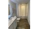 Well-lit bathroom featuring a granite-topped vanity and a shower-tub combination at 802 Major Oak Ct, Villa Rica, GA 30180
