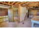 Basement showing exposed framing, utilities, and unfinished areas ready for renovation and customization at 1295 Maple St Se, Conyers, GA 30013