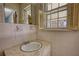 A small bathroom with a sink and window at 1295 Maple St Se, Conyers, GA 30013