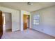 Bedroom with carpeted floors, a window, a closet, and neutral-colored walls at 1295 Maple St Se, Conyers, GA 30013