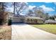 Beautiful ranch-style home with a spacious driveway and attached carport at 1295 Maple St Se, Conyers, GA 30013
